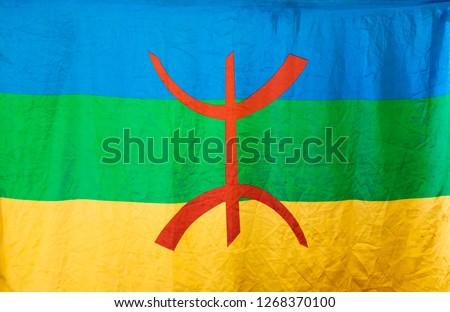 Amazigh flag. Berber flag proposed by the Amazigh World Congress in 1997 Royalty-Free Stock Photo #1268370100