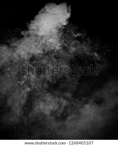 A black & grey smoky fog in motion over a black backdrop.