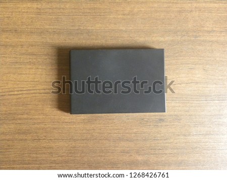 Black color plastic external hard disk drive kept on wooden table