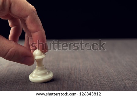 man plays chess and makes the first move a pawn