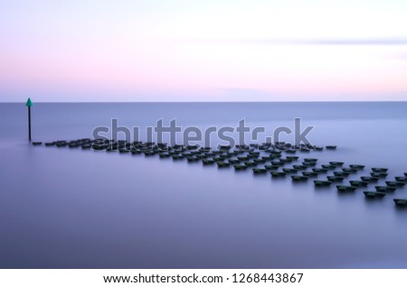 Long Exposure Photograph breakwater at sunset