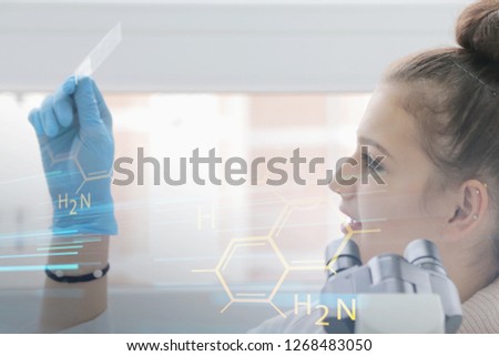 Young female Laboratory scientist working at lab with test tubes and microscope, test or research in clinical laboratory.Science, chemistry, biology, medicine and people concept.