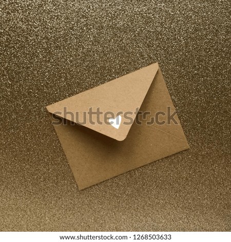 envelope with a gold heart on a gold background of sparkles for Valentines Day. Love Message Valentine.