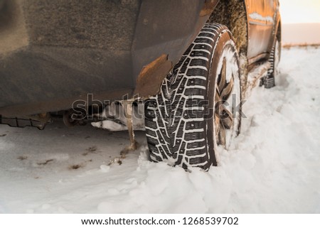 Moscow, Russia - December 25, 2018: The wheel is buried in the snow. The off-road car goes on a winter field.