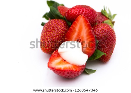 The ripe strawberries with the white cream 