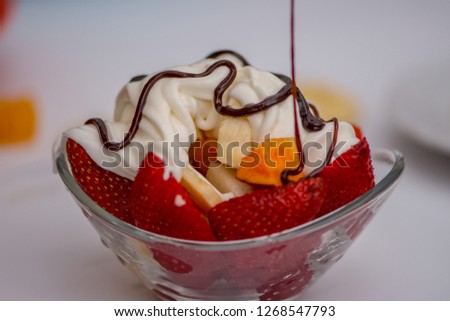 The fruit salat with the cream and chocolate  prepared in the gl