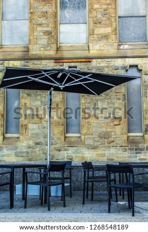 Exterior bistro tables and chairs adjacent to old church