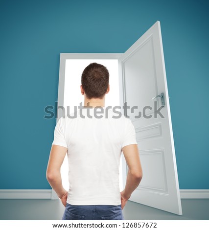 guy in T-shirt looking at  opened door