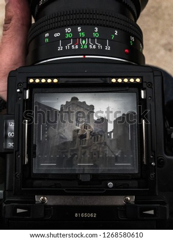 A medium format camera viewfinder focused on an abandoned and crumbling church