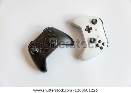 White and black two joystick gamepad, game console isolated on white background. Computer gaming technology play competition videogame control confrontation concept. Cyberspace symbol