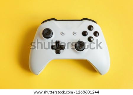 White joystick gamepad, game console on yellow colourful trendy modern fashion pin-up background. Computer gaming competition videogame control confrontation concept. Cyberspace symbol