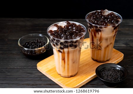 Taiwan milk tea with bubble on wood background Royalty-Free Stock Photo #1268619796