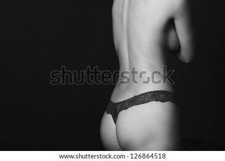 black and white photo of a girl in panties