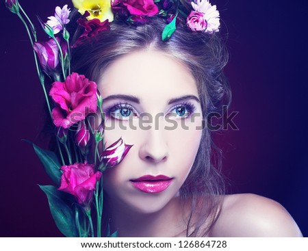 Girl with flowers in her hair and in her hands