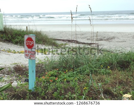 Sign on Beach That Says Stop No Vehicles Beyond This Point 