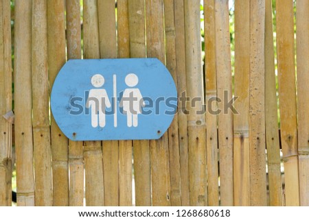 
Sign Is the bathroom sign of women and men Stuck at the edge of the fence to tell the way to the bathroom.