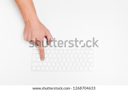 A man hand using a wireless keyboard isolated on white.
