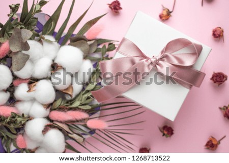 gift box with bouquet of dried flowers
cotton flowers, lagurus ovatus. pink spikes, palm leaves. eucaliptus