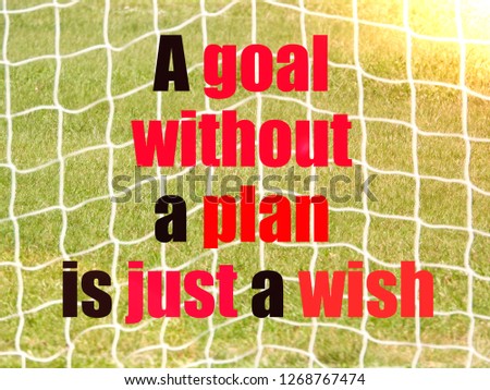 Soccer Goal Net and words A GOAL WITHOUT A PLAN IS A JUST A WISH on Green Grass Background with selective focus and crop fragment. Business and motivation concept