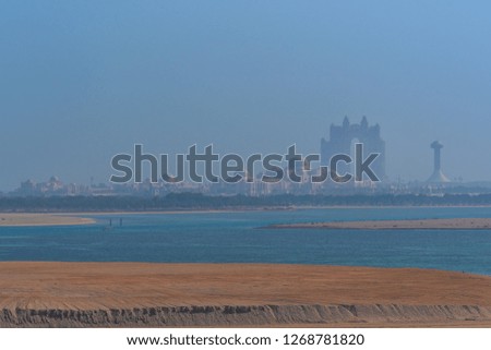 Photo taken from the deck of the ship in the Mussafah channel, a large shoal and view of the Abu Dhabi Palace, a picture that naturally reflects the unfinished surroundings