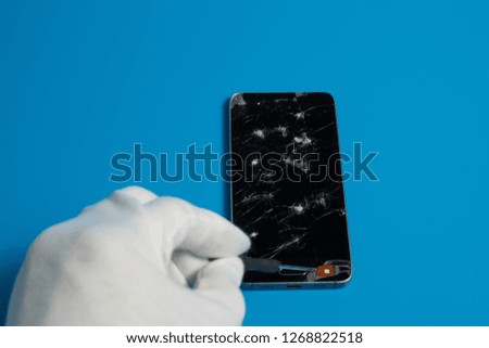 Repair smartphones with a broken screen on a blue background