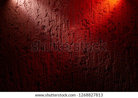 Two beams of pink and red color cross over a textural background