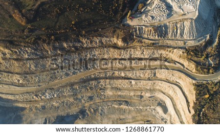 Panoramic view of quarry. Shot. Top view of picturesque quarry located on coastal mountain near village in forest. Concept of mining