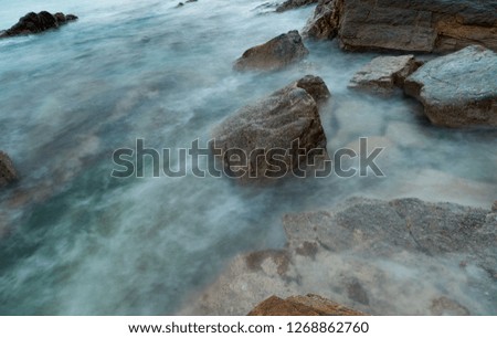 long exposure seashore using tripod motion water above stones lowtide