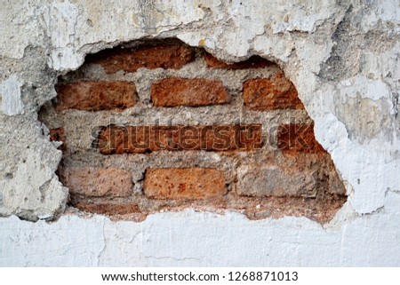  cracked concrete wall show red brick pattern texture                             