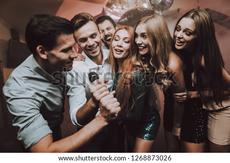 Boys Solo. Great Mood. Young People. Dance Club. Sing. Microphone. Trendy Modern Nightclub. Party Maker. Birthday. Karaoke Club. Celebration. Handsome Men. Beautiful Girls. Dancing People.