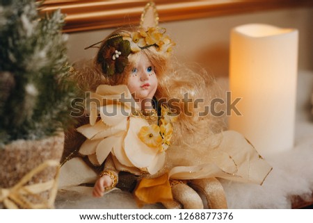 Beautiful angel in golden dress on a Christmas background.