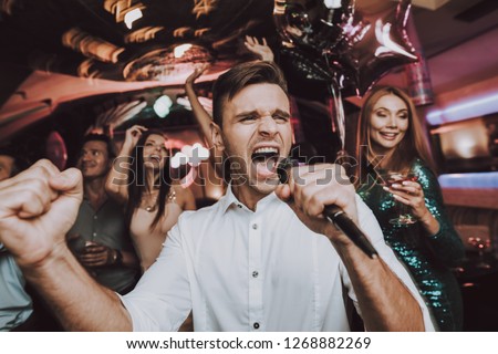Sing. Men. Microphone.Great Mood. Sing in Karaoke. Karaoke Club. Celebration. Dance Club. Holidays Concept. Dancing People. Young People. Trendy Modern Nightclub. Party Maker. Birthday. Men. Have Fun.