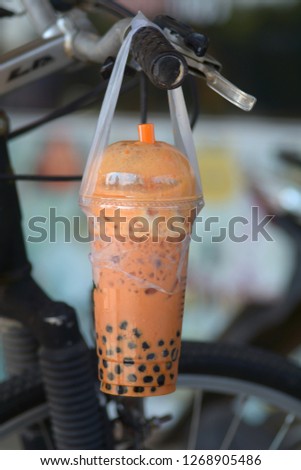 bubble tea in plastic glass Hanging with a bike