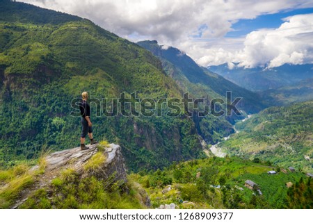 Man standing on top of the hill in Himalayas. Achievement and success. Trekking in Nepal