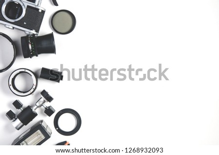 Old camera and photo accessories on white background