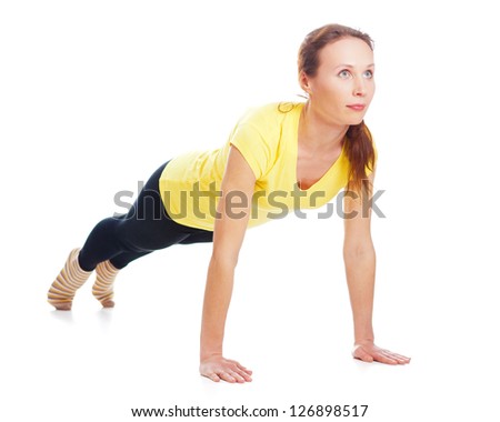 Young woman doing yoga exercise on a white background.