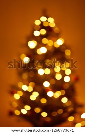 Blur image of bokeh christmas background, defocused lights decoration on christmas tree.