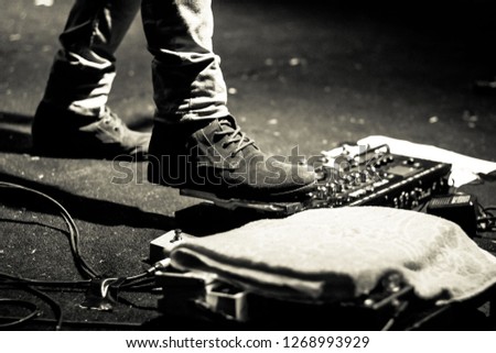 Foot Stepping on a Guitar Pedal Effect Royalty-Free Stock Photo #1268993929