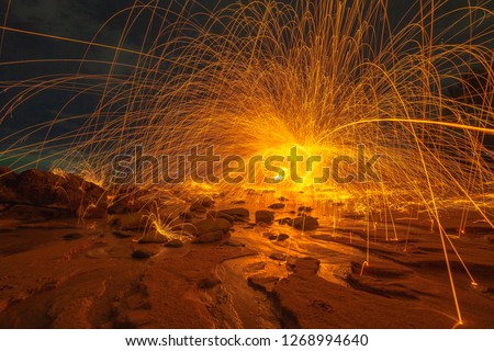 cool burning steel wool art fire work photo experiments on the beach at sunset