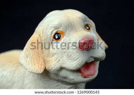 Souvenir plaster dog. Front view close up. Shallow depth of field