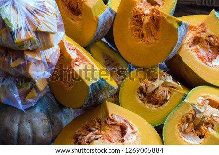 Background with ripe red pumpkin in the tropic market, there is a vegetable, picture use for advertising, design, packaging and more