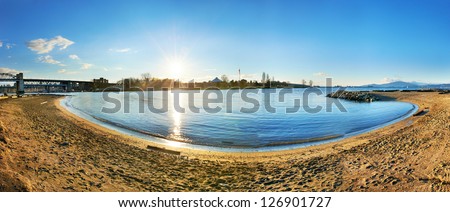 Panoramic view of Vancouver city from the sandy beach side. Sunset above the blue bay