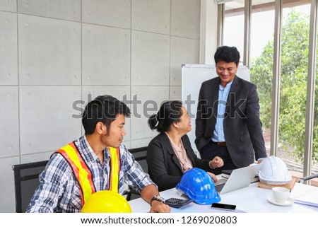 The manager is checking the work of the engineer team. Planning of engineers and technicians. Engineers and Architects Planning for a project. Asian people.