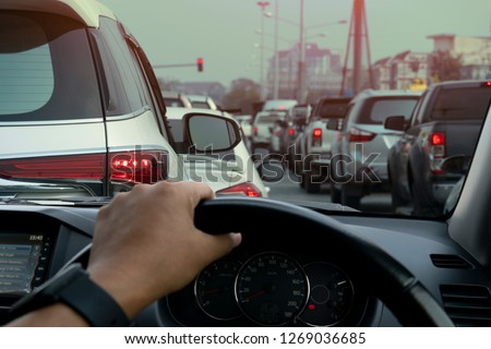 People driving inside car and many cars on the road jam in traffic junction by red light control, Rush hour in Thailand on day. Royalty-Free Stock Photo #1269036685