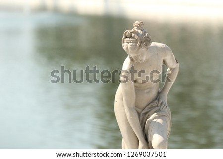 Ancient Greek woman statue on blur water background