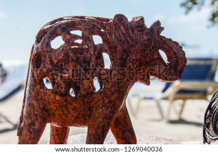 Wooden figurine of an Indian elephant on a beach