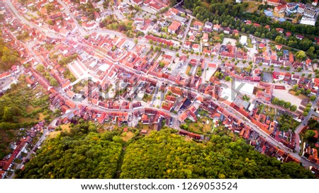 Aerial drone bird's eye view photo of european village of central europe with red roofs and cozy streets, beautiful natural morning sun lights