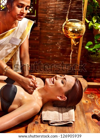 Young woman having Ayurveda spa treatment.