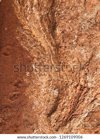 Close up of brown, marbled rock texture.