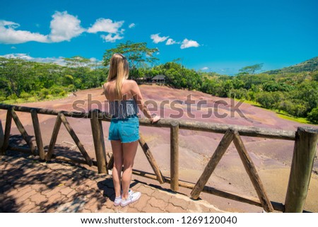 Girl looking at chamarel seven coloured earth.